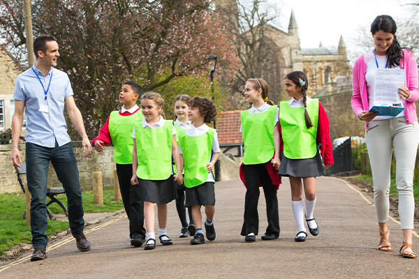 School trip with pupils in high vis jackets